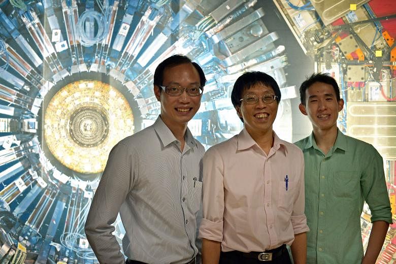 Mr Leong Qixiang (left) and Mr Tan Hong Qi (right) have spent time at the Collider as part of a Cern programme, which is coordinated here by associate professor Phil Chan (centre).