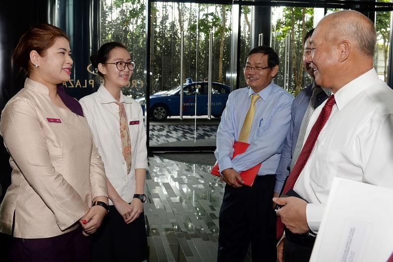 (From left) Interns Nur Sheba Mohd Yusoff and Cynthia Yong, both aged 19, from the Crowne Plaza Changi Airport hotel, are pursuing a Higher Nitec in hospitality operations. They met ITE deputy CEO (Industry) Aw York Bin, divisional director Ting Kok 
