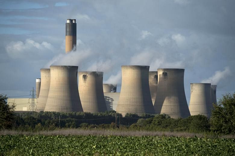 The cooling towers of a coal-fired power station near Selby, northern England. The United Kingdom plans to wind down coal-fired power plants, with plans to replace them with gas and nuclear stations.