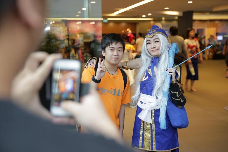 Cosplayers (above) taking a selfie. Mr James Ng (left), a contestant at the regional cosplay competition, spent $500 making his costume for Saint Seiya, and student Eileen Chee (below) dressed as Ashe from online game League Of Legends. Polytechnic s