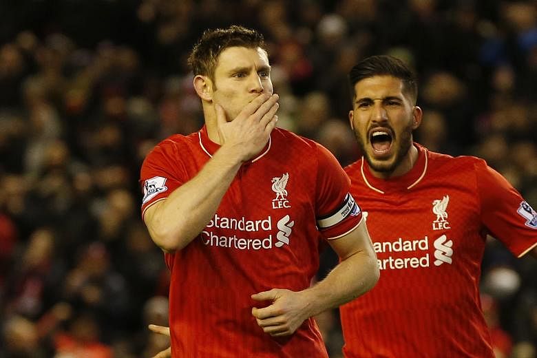 Liverpool captain James Milner celebrating with Emre Can after scoring from the penalty spot. That was the only goal in the game, which took the Reds to sixth place on the Premier League table.