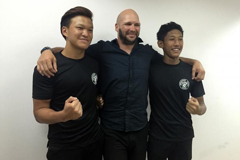 Marcus Ng Weii (left) and Muhammad Nur Solihin Mansor with former All Black Scott Waldrom after being selected from among 22 schoolboy rugby players for a two-week stint in Wellington.