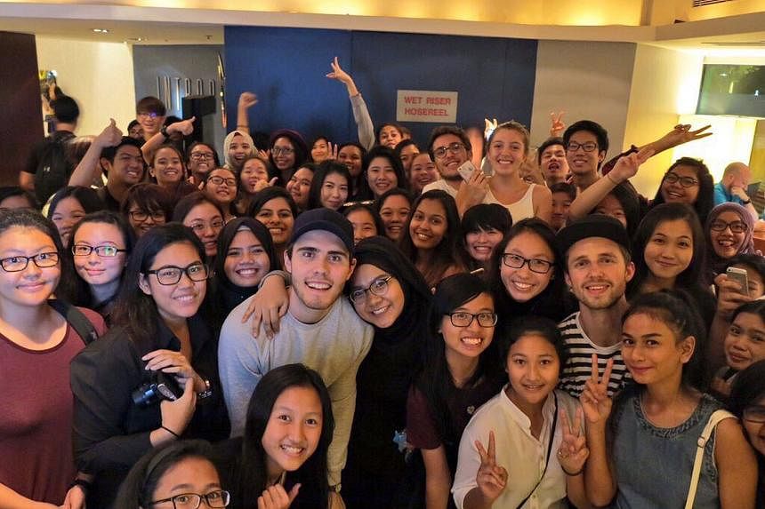 YouTubers Alfie Deyes and Marcus Butler; and with their fans at the Swissotel The Stamford hotel (above).