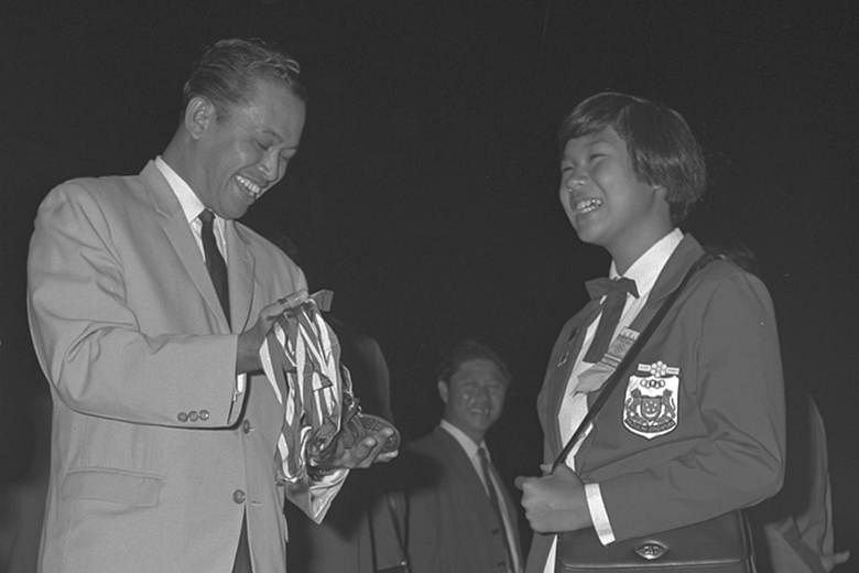 A young Patricia Chan had reason to beam as Minister for Social Affairs Othman Wok looked at the eight gold medals the 11-year-old won at the 1965 SEAP Games. Altogether, Chan (right, in later years) won 39 golds at five SEAP Games (later the SEA Gam