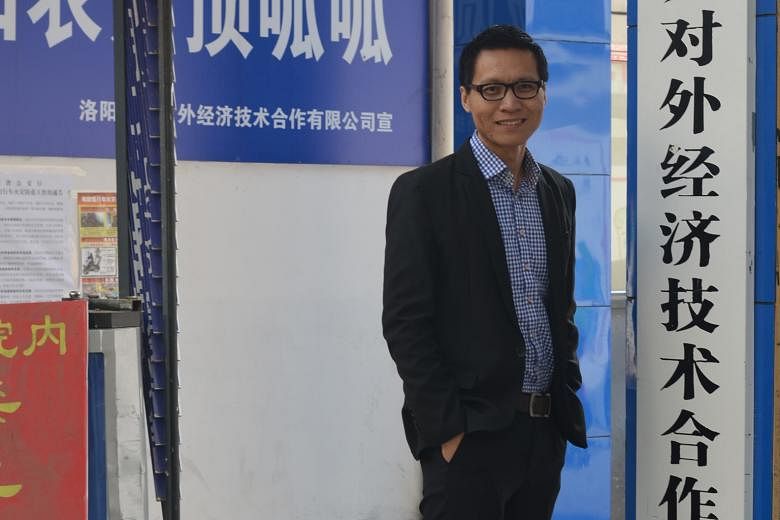 Mr Wang at Luoyang New- Link's branch in rural Songxian. As the firm's vice-general manager, he makes two to three times as much as he did in Singapore. Mr Wang Cheng Jun with his wife Zhang Limin, who works as a nurse in Singapore, and son Zi Hang d
