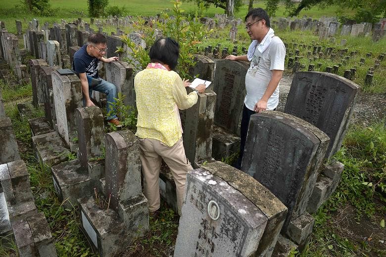 Madam Ong Poh Neo, great-granddaughter of Straits-born Chinese merchant and philanthropist Tan Jiak Kim, with her cousin, Mr Lloyd Tan (left), and grave hunter Raymond Goh at the Choa Chu Kang cemetery, where the graves of Mr Tan Jiak Kim, his wives,