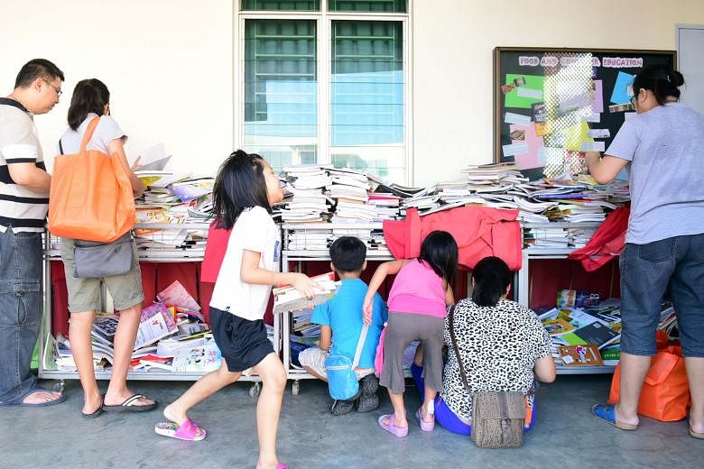 Free textbooks being distributed under the Share-A-Textbook Project by NTUC FairPrice at Gan Eng Seng School on Saturday.