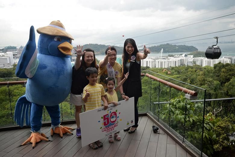 Mr Chuan Kai Liang, wife Caroline and children Julian and Olivia marking their winning moment with a photograph. With them is general manager Suzanne Ho (far right) of Mount Faber Leisure Group.