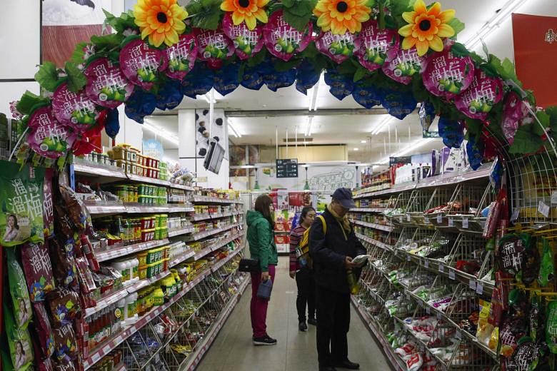 Shoppers in a supermarket in Beijing. Mr Manish Singhai of Lazard Asset Management is unperturbed by China's sluggish growth, saying that there is a "gradual but very meaningful move in the composition of the economy" with consumption taking off.