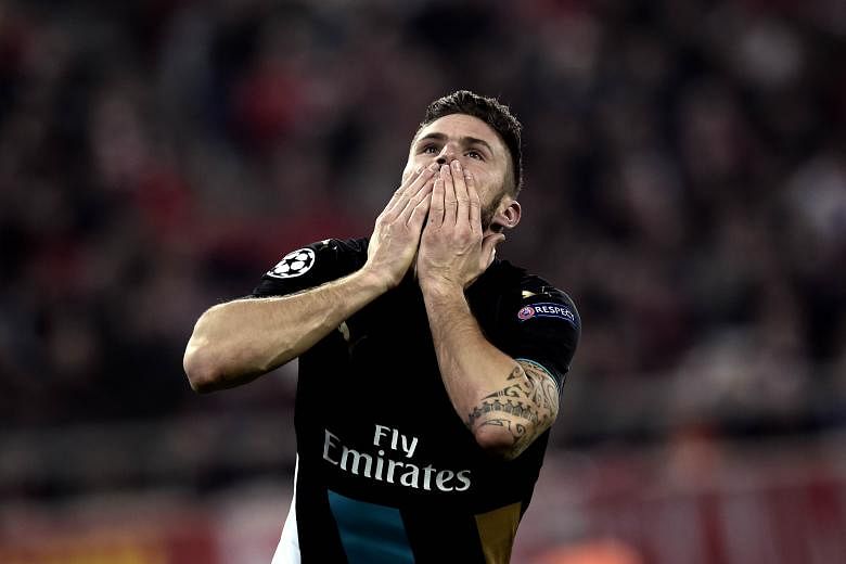 In-form strikers Olivier Giroud (left) of Arsenal and Luis Suarez of Barcelona will hope to fire on all cylinders when the two teams meet in the Champions League last-16 fixture. Arsenal, who made it through even after losing three of their opening f