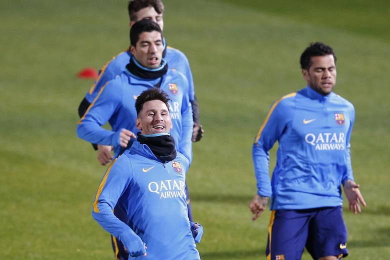 Barcelona players Lionel Messi (front) and Luis Suarez running during a training session ahead of their Club World Cup semi-final match tomorrow against Luiz Felipe Scolari's Guangzhou Evergrande in Yokohama.