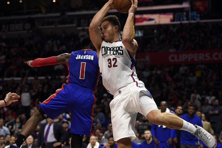 LA Clippers forward Blake Griffin (left) attempting to keep the ball in-bounds against Detroit Pistons guard Reggie Jackson in an earlier NBA game at Staples Center.