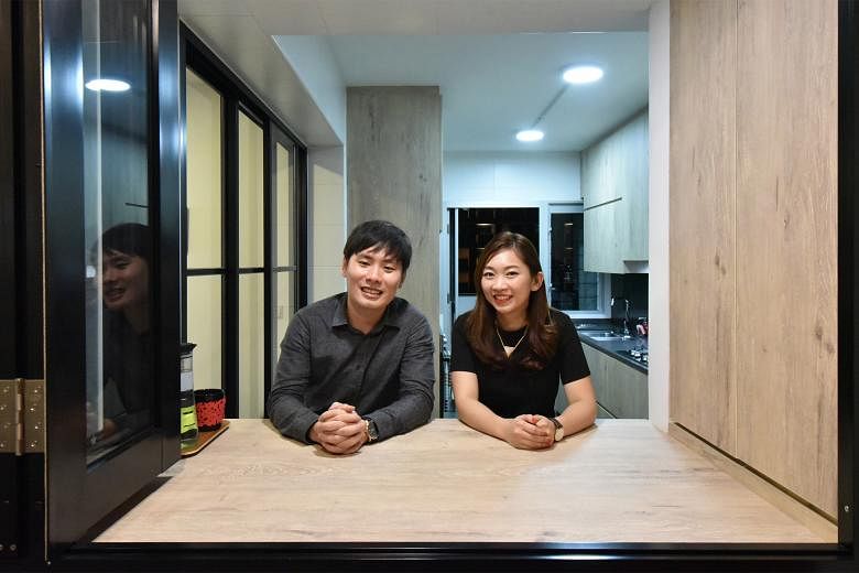 Owners Ow Khai Wan and Kimberly Chow (both left) housekeep on weekends to keep clutter at bay in their five-room HDB flat (above).