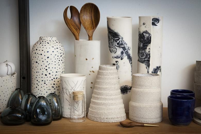 Ceramic containers at trendsetting boutique Still House (left) in Manhattan and at Primary Essentials (below right), a shop in Brooklyn; and designer Forrest Lewinger (below left) of Workaday Handmade sculpting at his studio in Queens.