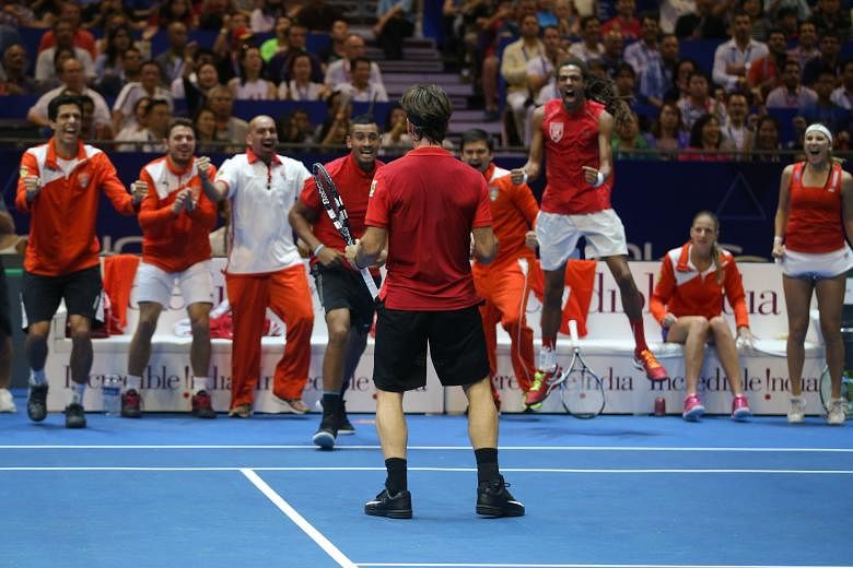 Stan Wawrinka (above) showed his pedigree when he won his singles and doubles matches yesterday to help the Singapore Slammers (left) win this year's IPTL and give home fans plenty to shout about.