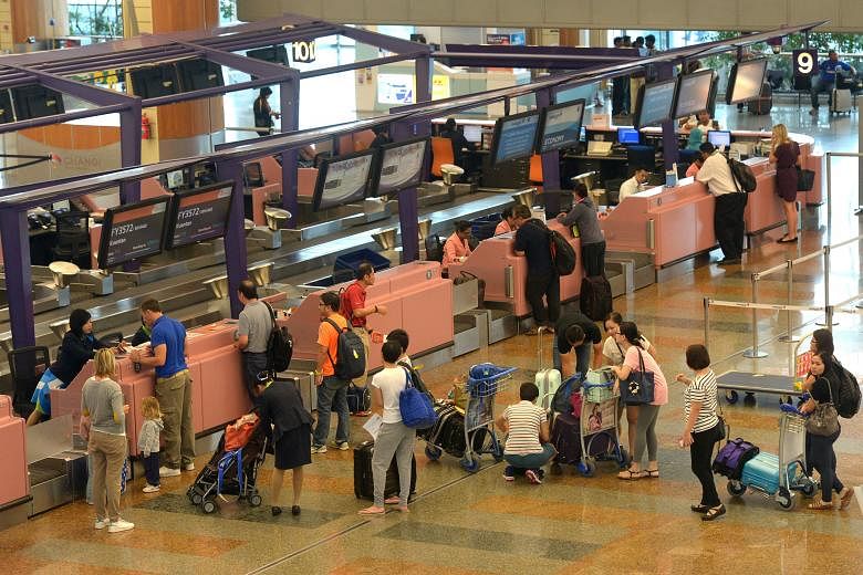Travellers at Changi Airport. Besides seamless travel within Asean, more than half of Singapore respondents expect their work or travel to increase in the next three years.