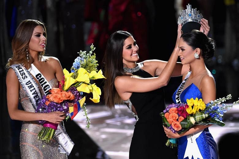Singapore's Ms Lisa Marie White on stage in her national costume at the Miss Universe pageant in Las Vegas. Ms Pia Alonzo Wurtzbach of the Philippines being crowned Miss Universe by last year's winner Paulina Vega. Ms Ariadna Gutierrez (left) of Colo