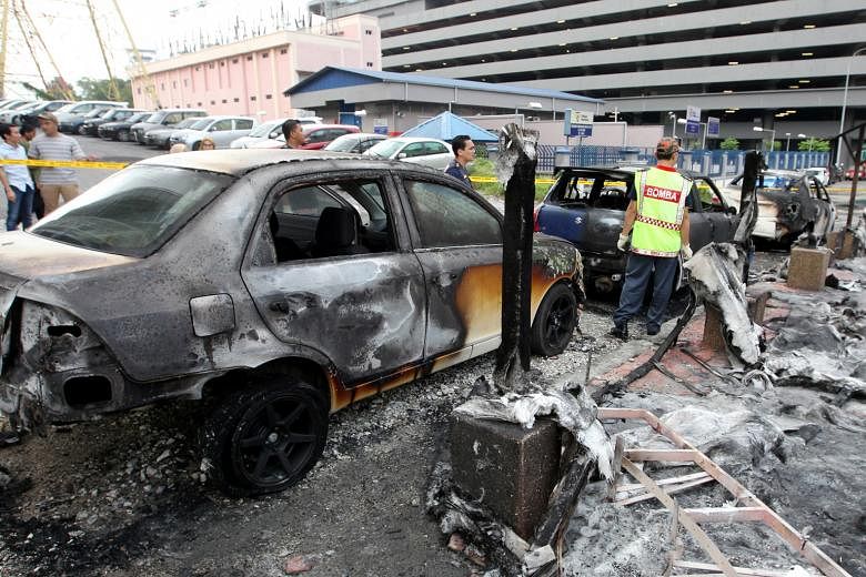 Six cars were damaged in the incident near an LRT station in Selangor on Monday. The suspect threw a petrol bomb at the car of his wife's boyfriend after an argument. The fire quickly spread to the other cars parked there, causing plumes of smoke and