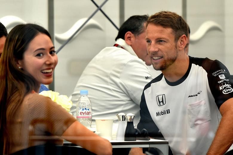 Jessica Michibata and Jenson Button relaxing in the paddock during the Japanese Grand Prix in September. The high-profile couple hardly lived together after they got married nearly a year ago.