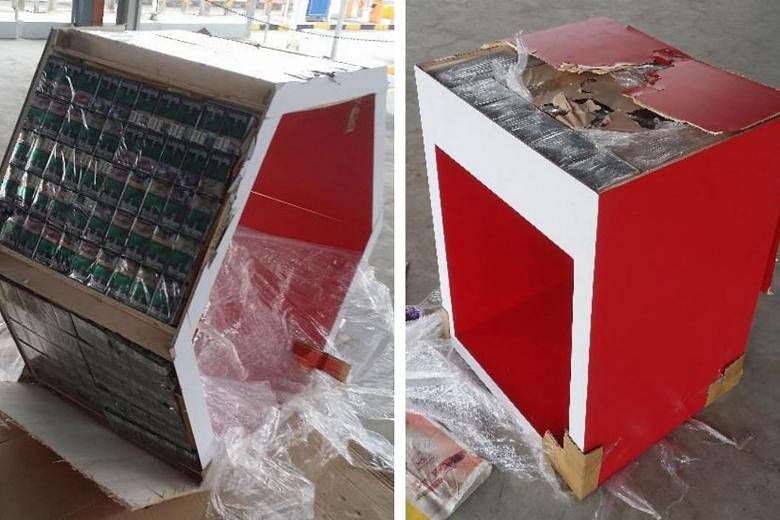 Last Friday, 1,648 cartons of cigarettes were found hidden in the base and side walls of cabinets and tables (above) in a lorry. The 48-year-old driver was arrested.