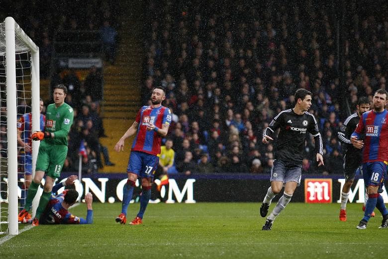 Crystal Palace players can only look on in despair, while Chelsea midfielder Oscar (right) wheels away in jubilation after scoring the opening goal at Selhurst Park in the Blues' 3-0 win.