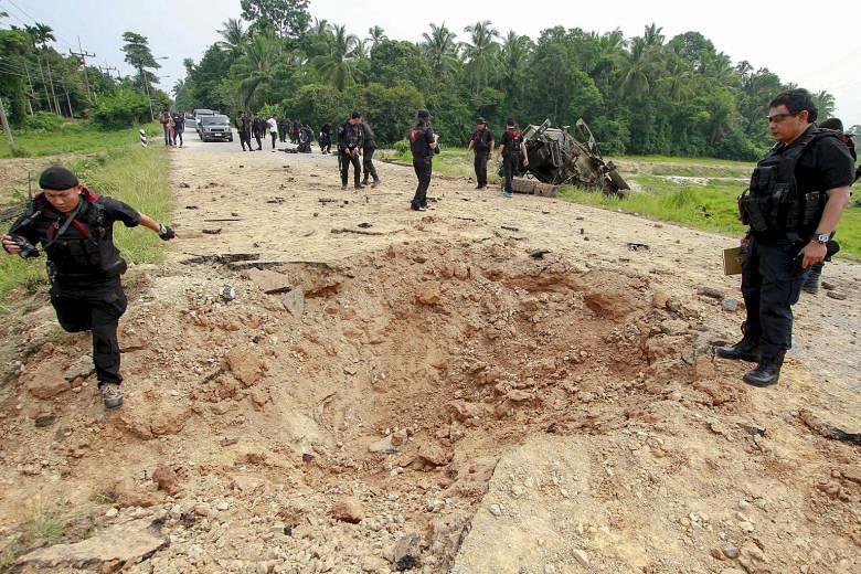 Military personnel inspecting the site where soldiers were attacked by suspected Muslim militants at Sai Buri district in the southern province of Pattani in Thailand last October. The separatist insurgency has claimed more than 6,500 lives and hinde