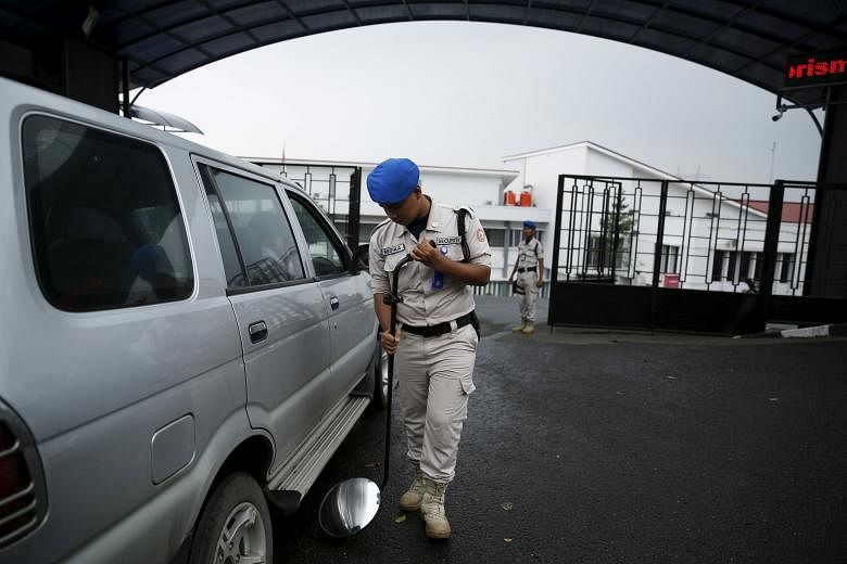A security guard checking a car outside the National Counter-Terrorism Agency building in Bogor on Tuesday. There is rising concern about possible attacks by ISIS sympathisers in Indonesia.