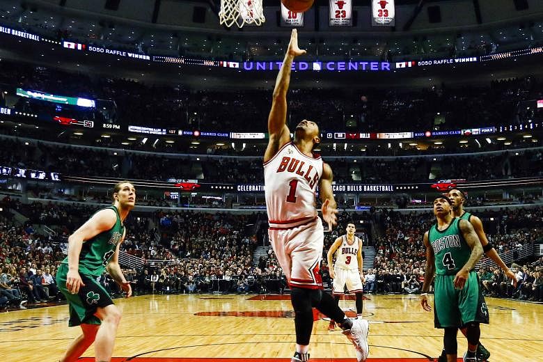 Bulls guard Derrick Rose scoring an easy basket as Celtics centre Kelly Olynyk (left) and guard Isaiah Thomas fail to keep pace at the United Centre. Chicago beat Boston 101-92 after trailing by 10 points late in the second half, netting at least 100