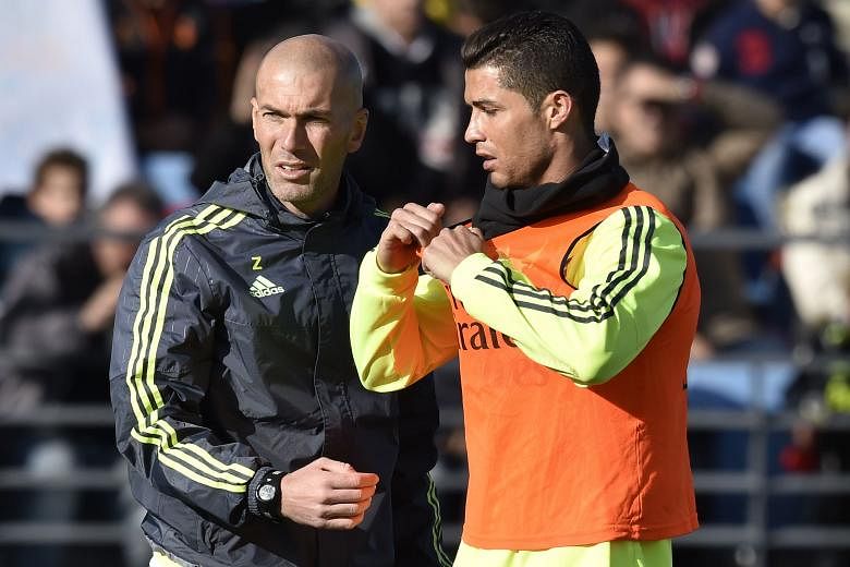 Real Madrid legend Zinedine Zidane (left) with forward Cristiano Ronaldo during his first training session as head coach on Tuesday.