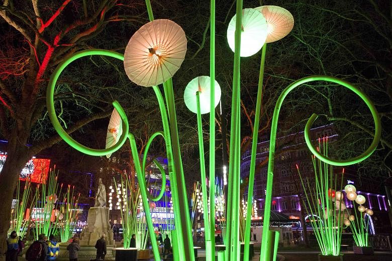 Visitors can walk around the Garden Of Light (above) by French art collective Tilt in Leicester Square. IFO (above) by French artist Jacques Rival. Litre Of Light by British artist Mick Stephenson. American artist Janet Echelman's 1.8 installation ho