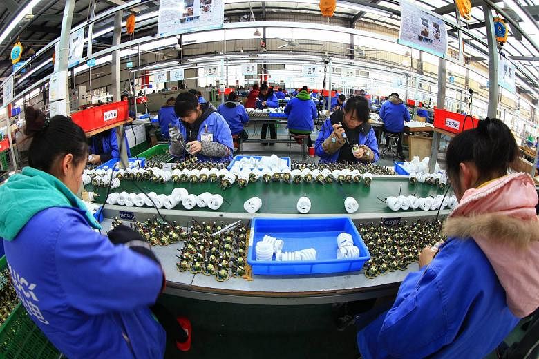 A light-bulb factory in China. Data from the Bank of International Settlements shows that mainland Chinese firms have debts totalling US$1.1 trillion (S$1.6 trillion). Will they face difficulties servicing their loans if the yuan plummets?