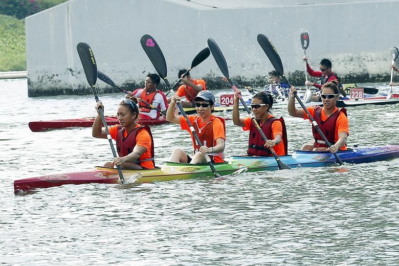 Minister for Culture, Community and Youth Grace Fu (second from left), guest of honour at the Singapore Canoe Marathon, testing out a Junior K4 boat at Marina Reservoir with national canoeists (from left) Stephenie Chen, Suzanne Seah and Sarah Chen -