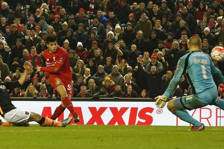 Liverpool's Joao Teixeira scoring the third goal against Exeter City in their FA Cup third-round replay. The Reds won the match 3-0 and will face West Ham in the fourth round.