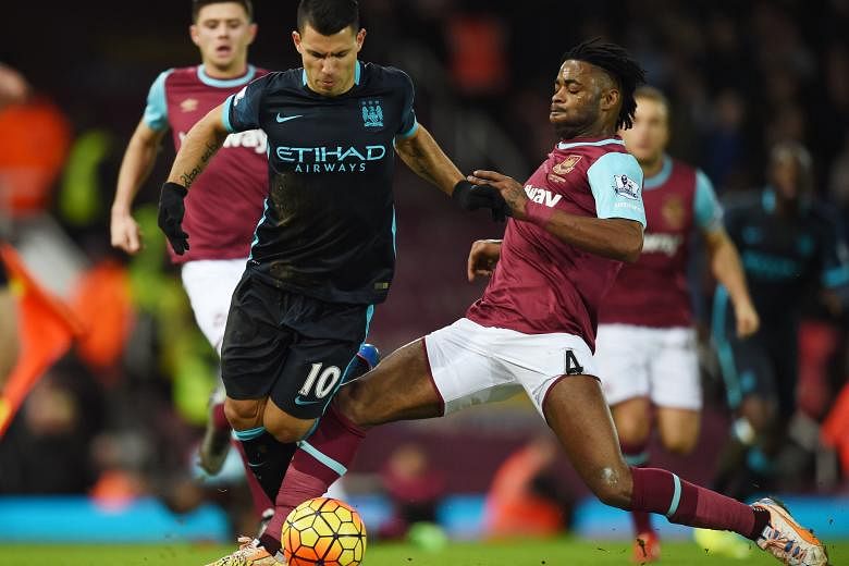 Manchester City's Sergio Aguero (left) challenging West Ham's Alex Song for the ball in the 2-2 draw. Aguero scored both goals and now has 15 goals in 22 matches this term, despite injuries limiting his appearances.