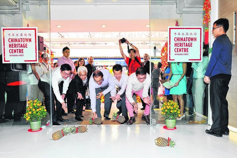 The revamped Chinatown Heritage Centre at 48, Pagoda Street opened its doors yesterday - to five pineapples rolled in by VIP guests for luck and prosperity. Doing the honours were (from left) Chinatown Business Association chairman Bernard Leong, the