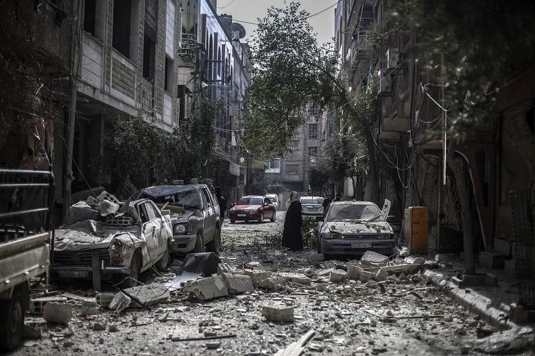 The war in Syria has claimed the lives of at least a quarter of a million Syrians and displaced 11 million. It has also caused massive destruction. Above is the rebel-held area of Douma, near Damascus.
