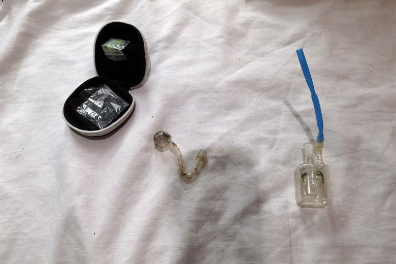 Above: A man, in his 20s, was arrested in a serviced apartment in Geylang following a raid by the Central Narcotics Bureau on Monday. Left: Officers found a pouch containing 0.2g of Ice and an improvised smoking device in the room.