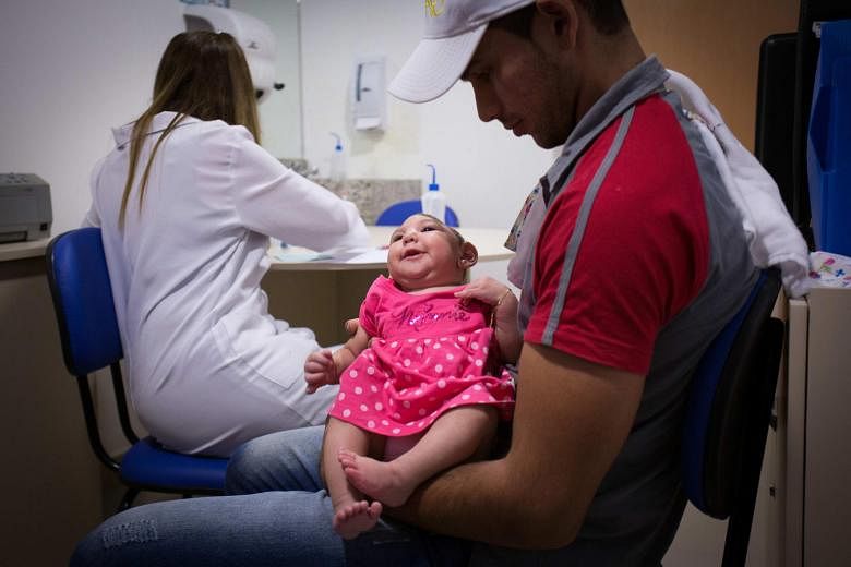 A father with his child (above) at a hospital in Recife, Brazil, last week. The Brazilian authorities are trying to shed light on the possible link between the Zika virus and more than 4,000 babies born with microcephaly since October. The country is