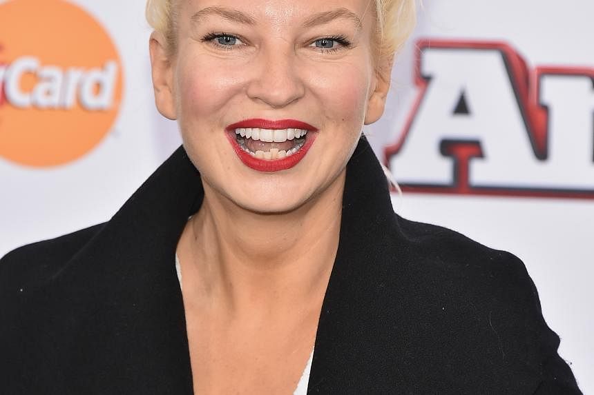 Singer Sia (above), who often hides her face to preserve her anonymity, returns to dark territory on her latest album by exploring abusive relationships.