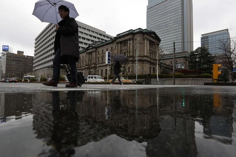 The Bank of Japan's headquarters in Tokyo. The BOJ's move to join the European Central Bank and others in driving their key benchmark interest rates to below zero helped drive the Dow up 2.5 per cent last Friday.