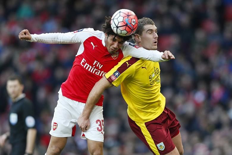 Mohamed Elneny (left), Arsenal's new €10 million (S$15.42 million) signing, gets the better of Burnley's Sam Vokes in the Gunners' 2-1 win in the fourth round of the FA Cup on Saturday.