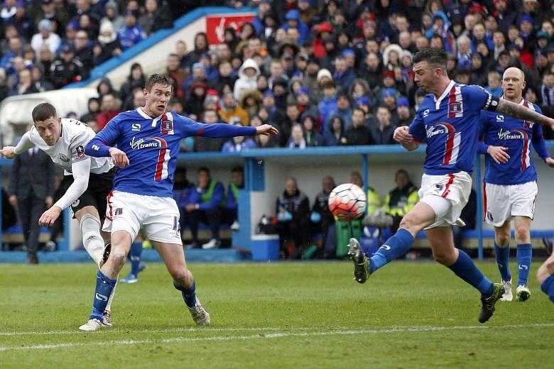 Everton's Ross Barkley (left) wrapping up Everton's 3-0 FA Cup fourth-round victory with his 65th-minute goal at League Two side Carlisle United yesterday. Arouna Kone opened the scoring after two minutes at the fourth-tier side's Brunton Park home b