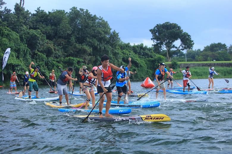 Paddlers participating in the Stand Up Paddling race yesterday afternoon at Lower Seletar Reservoir. It was one of the activities at the Seletar Speed Crossing event, a competition organised by Singapore Sailing and the Seletar Country Club to record
