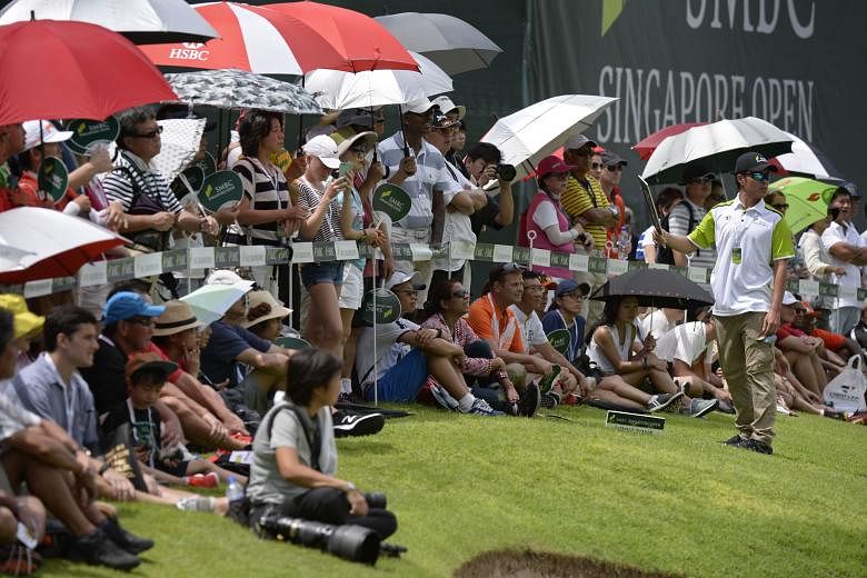 Spectators gather at the 18th hole at Sentosa Golf Club's Serapong Course at the SMBC Singapore Open yesterday. The tournament drew close to 20,000 spectators from Thursday to yesterday.