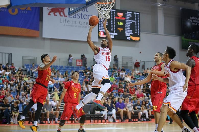 The Singapore Slingers' American import Xavier Alexander (in white) attempting a shot during an Asean Basketball League (ABL) game against the Saigon Heat yesterday. The Slingers beat their opponents 84-69 to extend their winning streak in the ABL to