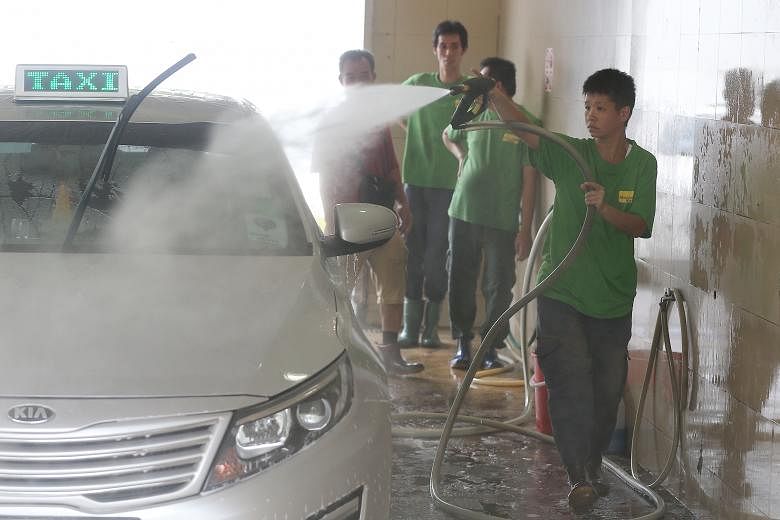 Ms Lim at work at the SPC petrol station in Telok Blangah. She is one of 30 trainees who have found work at the car wash. Since 2004, SPC has been providing the venue to Minds Wash at no cost.