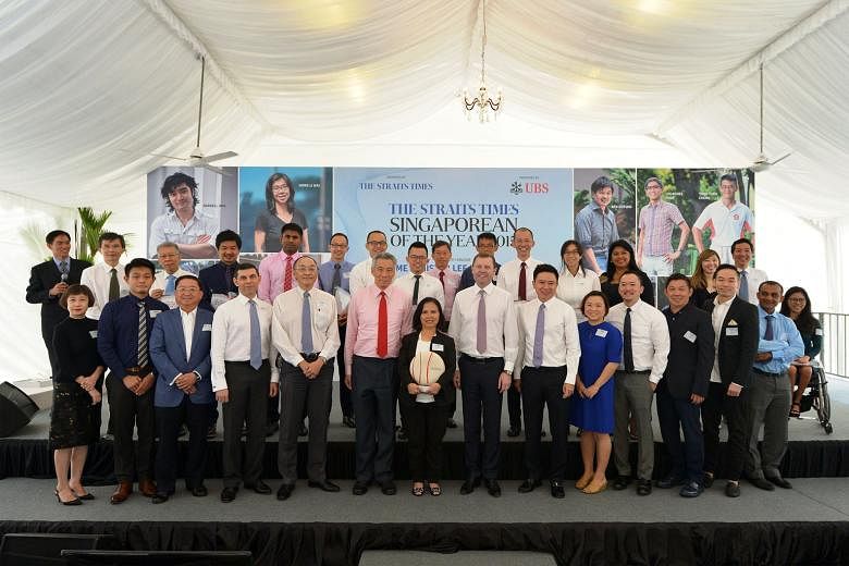 At the ST Singaporean of the Year award ceremony yesterday were (back row, from left) Kiss92 senior presenter Arnold Gay; finalist community volunteer Ang Thiam Hock; Mr Freddie Ang, father of finalist conductor Darrell Ang; finalists charity founder