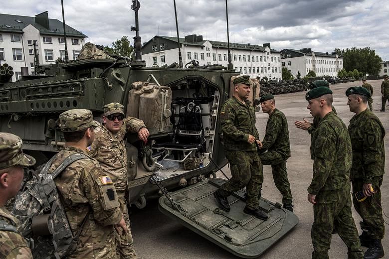 Lithuanian soldiers inspecting a Stryker armoured vehicle belonging to the Pennsylvania National Guard during military exercises in Lithuania last year. The US plans on paying for additional weapons with a budget request of more than $4.8 billion for