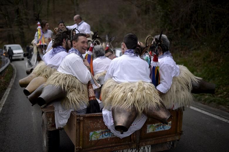Dancers known as Joaldunak on their way to a neighbouring village during carnival celebrations in Ituren, northern Spain, on Monday. The bell-carrying dancers from Zubieta and neighbouring Ituren visit each other's villages and perform a ritual dance