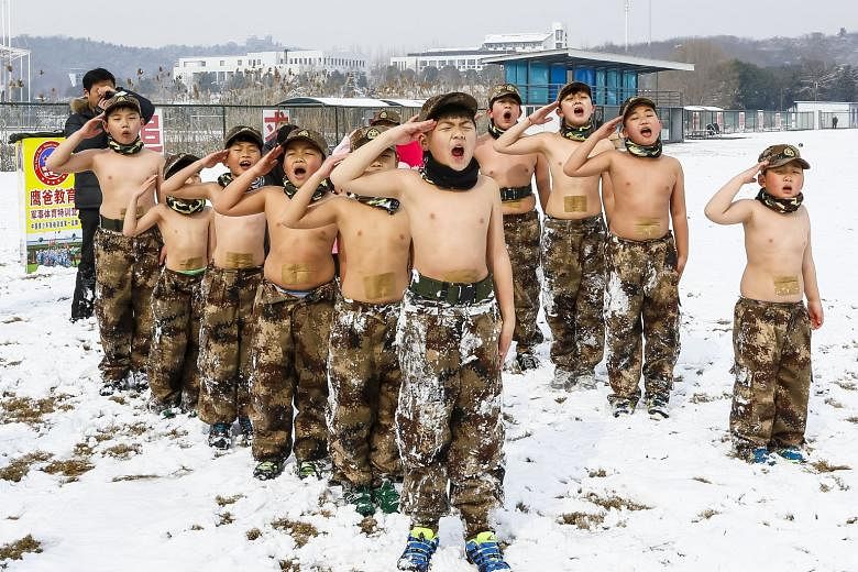 Children taking part in military-style training in snowy Nanjing, Jiangsu province, on Monday. The session was organised by entrepreneur He Liesheng, whose extreme parenting skills have earned him the nickname "Eagle Dad", in the vein of Chinese Amer